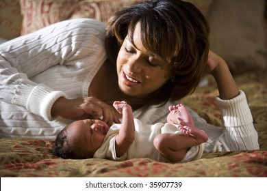 African American Mother Admiring Her Newborn Child