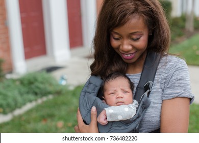 African American Mother With Baby In Carrier