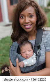 African American mother with baby in carrier