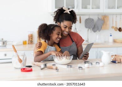 African American Mother And Daughter Baking Together At Home, Watching Online Culinary Blog, Using Digital Tablet, Happy Black Mom And Teen Kid Making Dough For Pastry, Taking Selfie On Pad