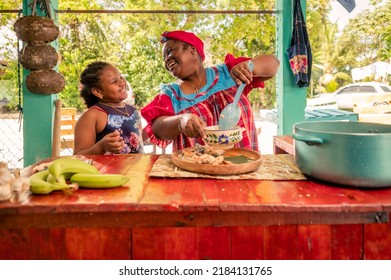 African American Mother And Daughter Or Grandmother And Granddaughter Enjoy The Moment Of Being Together In The Kitchen. Happy Family In The Kitchen.