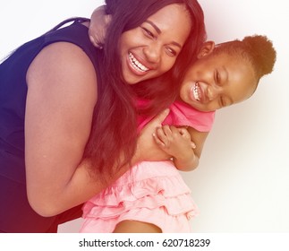 African American Mother Daughter Hug Together Studio Portrait