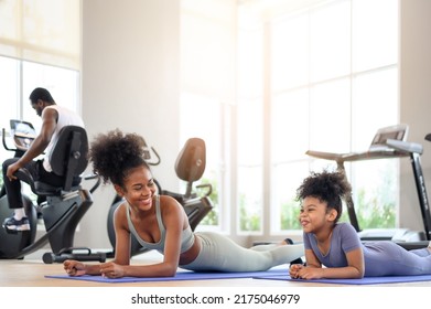 African American Mother And Daughter In Sportswear Practicing Yoga Together On Yoga Mat At The Gym. Black Family Sporty Fitness Workout