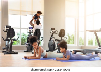 African American Mother And Daughter In Sportswear Practicing Yoga Together On Yoga Mat At The Gym. Black Family Sporty Fitness Workout