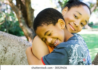 African American Mother Hugging Son