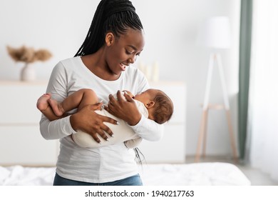 African American mother singing lullaby for infant to sleep