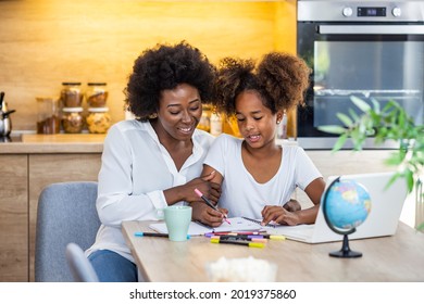 African American Mother Is Teaching Her Daughter Are Using Laptop At Home Together. Mother And Daughter Studying With Laptop. Woman And Child Using A Laptop Together 