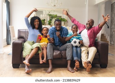 African american multi-generational family cheering while watching soccer match on tv. unaltered, lifestyle, sport, fans, family, watching tv, soccer match, cheering and leisure concept. - Powered by Shutterstock