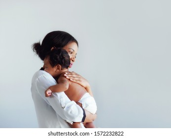 African American mum is comforting a baby on a white background.