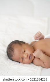 African American New Born Baby Lying On White Bed