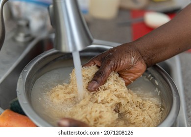 African American Nigerian Woman Washing Rice Before Cooking