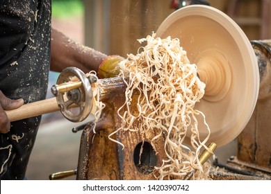 An African American Older Man Creates Works Of Art Through Bowl Turning On A Lathe. This Shows A Close Up View Of His Work While On The Lathe Machine.