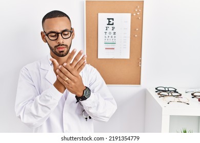 African American Optician Man Standing By Eyesight Test Suffering Pain On Hands And Fingers, Arthritis Inflammation 