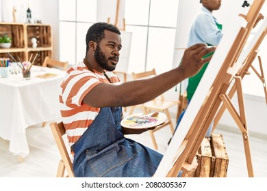 African american painter couple and serious expression painting at art studio 
