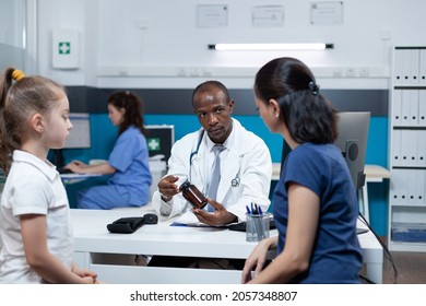 African American Pediatrician Doctor Explaining Medication Stock Photo ...