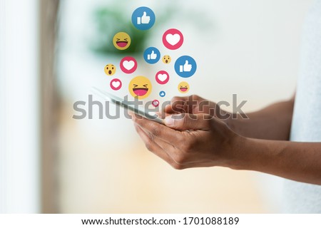 African american person holding a tactile mobile smartphone sending text messages emoji emoticon - Black people