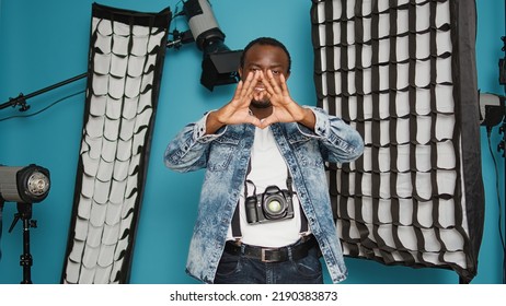 African American Photographer Doing Heart Shape Symbol With Hands, Psoing With Romantic Love Gesture Over Background With Photography Lighting Equipment. Valentines Day Feelings Sign.