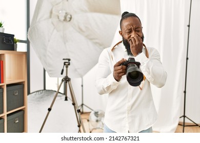 African American Photographer Man Working At Photography Studio Looking Stressed And Nervous With Hands On Mouth Biting Nails. Anxiety Problem. 