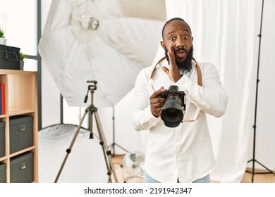 African American Photographer Man Working At Photography Studio Hand On Mouth Telling Secret Rumor, Whispering Malicious Talk Conversation 