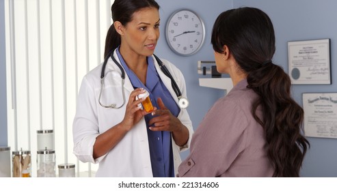 African American physician talking to hispanic patient about medicine