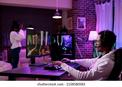 African american player streaming online video games play on pc, using computer to have fun with esport gaming tournament. Male gamer playing action game championship on internet.