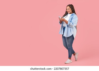 African American Plus Size Female Using Smartphone Texting Standing Posing On Pink Background, Studio Shot. Great Mobile App Concept. Full Length, Copy Space