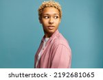 African american pretty millennial girl with blond curls turning head to scary sound looking aside with fear in eyes, full of anxiety and worry, feeling panic, terrified with strange noise