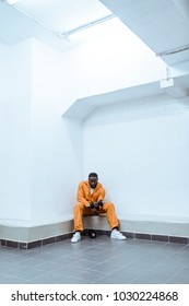 African American Prisoner In Light Modern Prison Cell