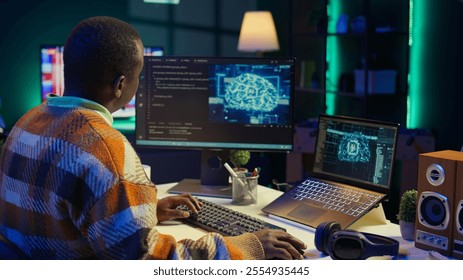 African american IT professional managing AI system for machine learning, coding software on terminal window. Futuristic interface program focuses on cybersecurity, networking for database. Camera B. - Powered by Shutterstock - Get 15% off with code: PIKWIZARD15