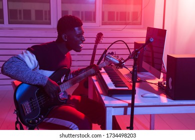 African American Professional Musician Recording Bass Guitar In Digital Studio At Home, Music Production Technology Concept.