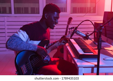 African American Professional Musician Recording Bass Guitar In Digital Studio At Home, Music Production Technology Concept.