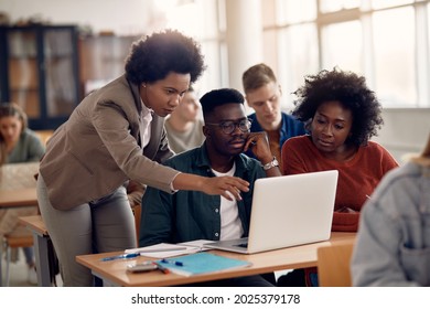 African American professor and her students using laptop during lecture in the classroom. - Shutterstock ID 2025379178