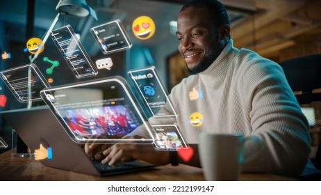 African American Project Manager Working on Computer in Office. Augmented Reality Social Media Icons Appear From Worker's Laptop. Internet of Things, Internet Connectivity and Online Concept.