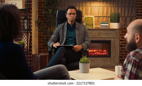 African American Psychologist Listening To Married People At Couple Therapy Session In Office, Talking About Problems. Doing Counseling To Help Save Marriage From Divorce, Psychotherapy Help.