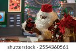 African american Saint Nick prepares a wrapped gift box in his workshop, using ribbons and bows. Santa spreading the festive holiday spirit during winter, x mas magic and fantasy. Camera A.