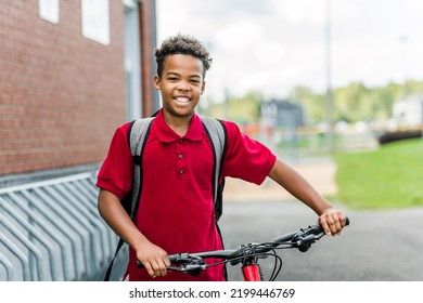 A African American School Boy With Backpack And Bike