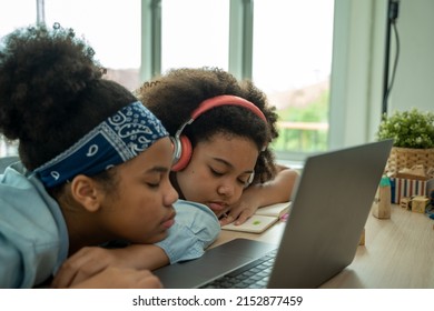 African American School Children Sleeping On Desk At Classroom,Girl Is Tired And Sleeps.