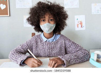 African American School Kid Child Girl Wearing Face Mask Looking At Camera Web Cam Learning Online Class. Virtual Social Distance Remote Education For Children Covid Protection. Webcam View, Headshot.