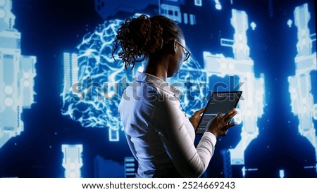 African american scientist programming scripts on tablet, employing AI machine learning infrastructure. Licensed employee manipulates lines of code for artificial intelligence applications development