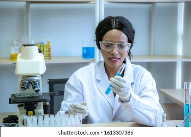 African American Scientist Woman Staring Test Tube