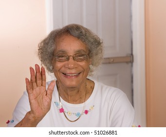 African American senior citizen waving and smiling