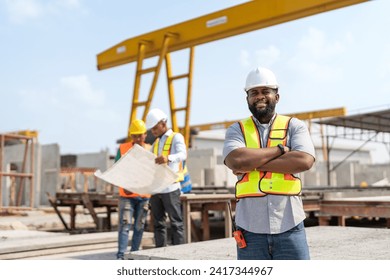 African American senior civil engineer or project manager standing and crossed arm with team worker behind at construction site factory produce precast concrete - Powered by Shutterstock