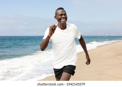 African American Senior Jogging At The Beach