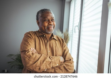 African American Senior Man at home Portrait. Smiling senior man looking at camera. Portrait of black confident man at home. Portrait of a senior man standing against a grey background - Shutterstock ID 2128747646