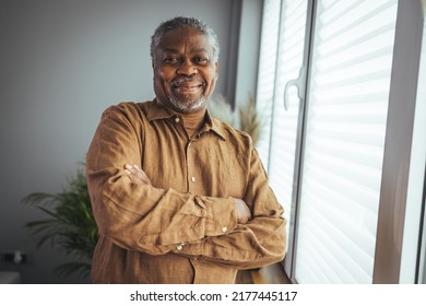 African American Senior Man at home Portrait. Smiling senior man looking at camera. Portrait of black confident man at home. Portrait of a senior man standing against a grey background - Shutterstock ID 2177445117
