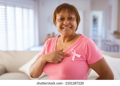 African american senior woman pointing at breast cancer awareness ribbon on pink t-shirt. identity and breast cancer awareness concept. - Powered by Shutterstock