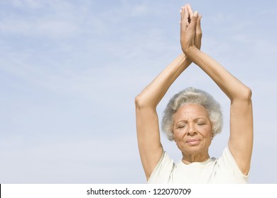 An African American Senior Woman Practicing Yoga Against Sky