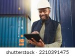 African american shipyard worker, shipping logistics and transportation of international commercial goods. Tablet for inventory management, import and export of cargo in the distribution supply chain