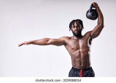 African american shirtless man lifting up kettlebell isolated on white studio background. Black body builder doing functional training basic exercise. Bodybuilding, weightlifting, sport, fitness - Powered by Shutterstock