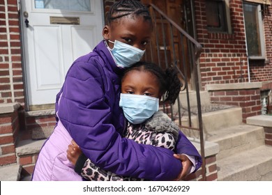 African American Sisters wearing Surgical Masks